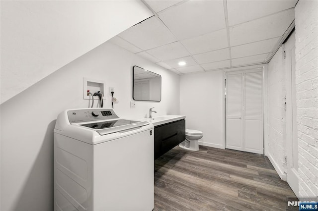 7 Edgewater Pl, Edgewater, NJ 07020 - clothes washing area with washer / dryer, wood finished floors, and brick wall