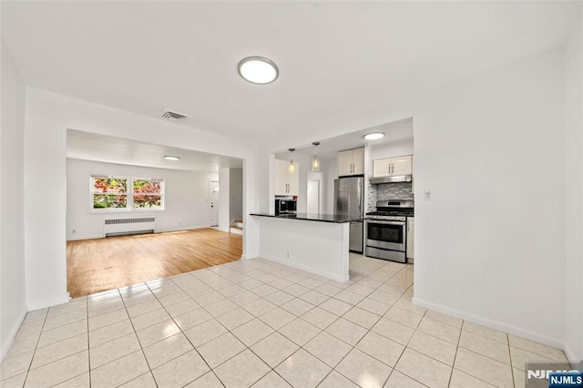 7 Edgewater Pl, Edgewater, NJ 07020 - kitchen featuring appliances with stainless steel finishes, radiator heating unit, open floor plan, light tile patterned flooring, and dark countertops
