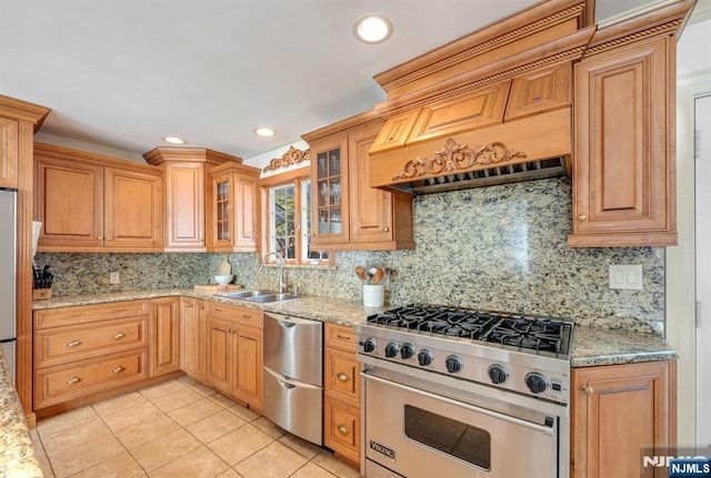 32 Brookside Dr, Upper Saddle River, NJ 07458 - kitchen featuring appliances with stainless steel finishes, decorative backsplash, a sink, light stone countertops, and light tile patterned floors