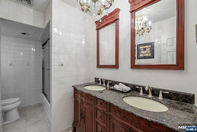 32 Brookside Dr, Upper Saddle River, NJ 07458 - full bathroom featuring toilet, tile walls, double vanity, enclosed tub / shower combo, and tile patterned floors