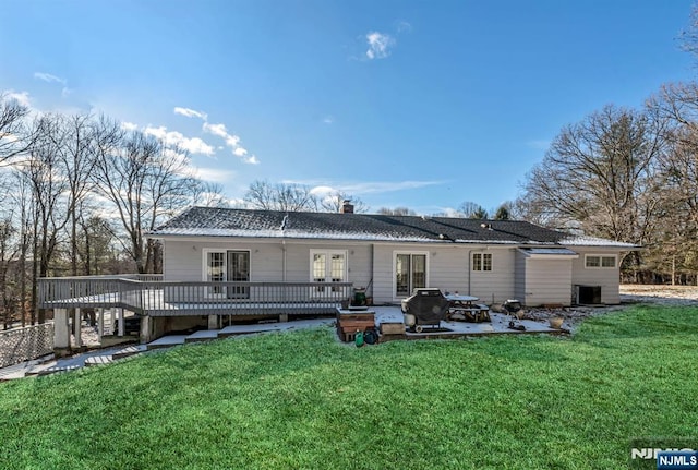 32 Brookside Dr, Upper Saddle River, NJ 07458 - rear view of property featuring french doors, a wooden deck, a patio area, a yard, and a chimney