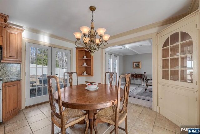 32 Brookside Dr, Upper Saddle River, NJ 07458 - dining area with light tile patterned floors, french doors, crown molding, and a chandelier