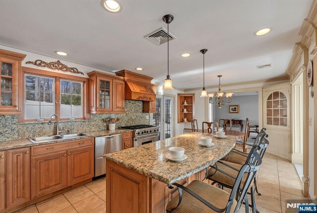32 Brookside Dr, Upper Saddle River, NJ 07458 - kitchen with a sink, appliances with stainless steel finishes, a kitchen breakfast bar, custom exhaust hood, and backsplash