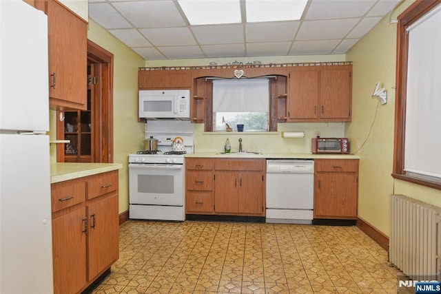501 Collins Ave, Hasbrouck Heights, NJ 07604 - kitchen featuring radiator, white appliances, light countertops, a drop ceiling, and light flooring