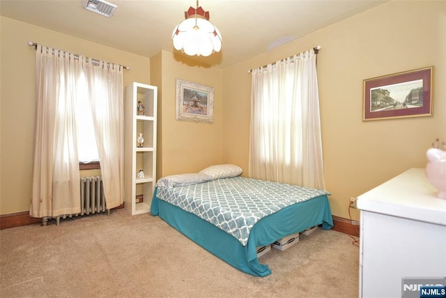 501 Collins Ave, Hasbrouck Heights, NJ 07604 - carpeted bedroom with multiple windows and radiator heating unit