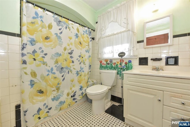501 Collins Ave, Hasbrouck Heights, NJ 07604 - bathroom with tile walls, vanity, crown molding, shower / tub combo with curtain, and tile patterned floors