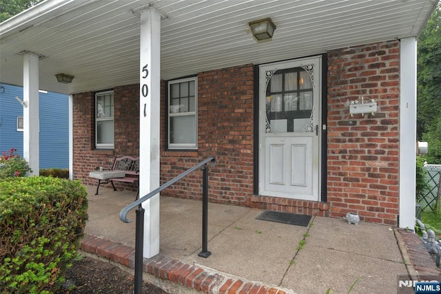 501 Collins Ave, Hasbrouck Heights, NJ 07604 - view of exterior entry featuring a porch and brick siding