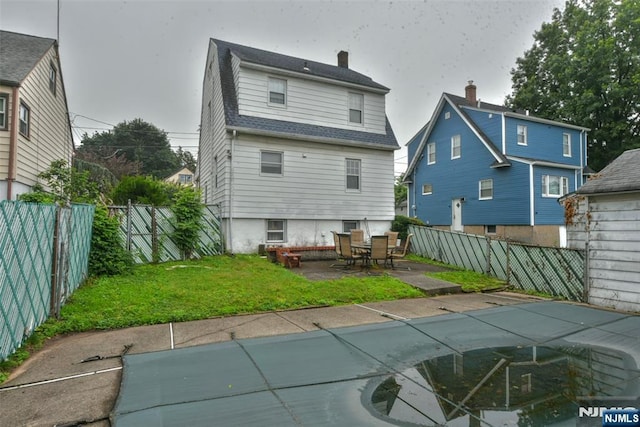 501 Collins Ave, Hasbrouck Heights, NJ 07604 - back of house with a patio area, a fenced backyard, and a shingled roof