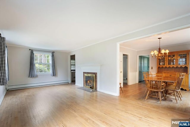 35 Mccosh Rd, Clifton, NJ 07043 - living area with a baseboard radiator, light wood finished floors, ornamental molding, a fireplace with flush hearth, and a chandelier