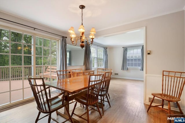35 Mccosh Rd, Clifton, NJ 07043 - dining area with ornamental molding, a chandelier, light wood-type flooring, and wainscoting