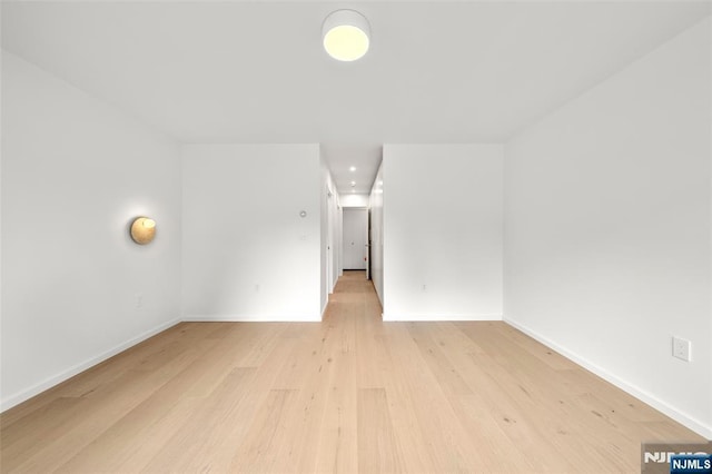 spare room with light wood-style floors and baseboards