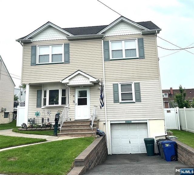 view of front of house featuring entry steps, an attached garage, and asphalt driveway