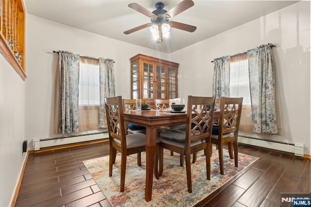 dining room featuring a baseboard radiator, wood tiled floors, ceiling fan, and baseboards