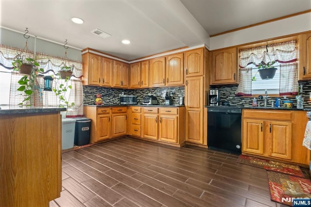 kitchen featuring dishwasher, dark countertops, tasteful backsplash, crown molding, and a sink