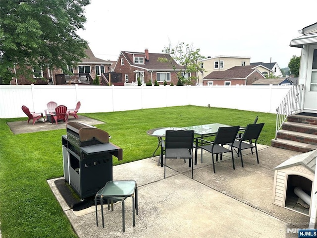 view of patio with grilling area, outdoor dining space, and a residential view