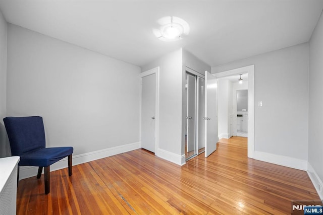 unfurnished room with baseboards and light wood-type flooring