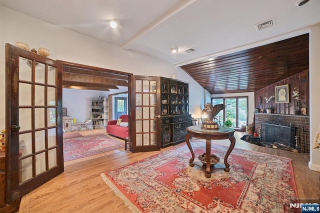 41-21 Dunkerhook Rd, Fair Lawn, NJ 07410 - living area with french doors, a fireplace, wood finished floors, and vaulted ceiling