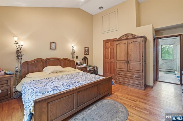 41-21 Dunkerhook Rd, Fair Lawn, NJ 07410 - bedroom with light wood finished floors, high vaulted ceiling, and a baseboard heating unit