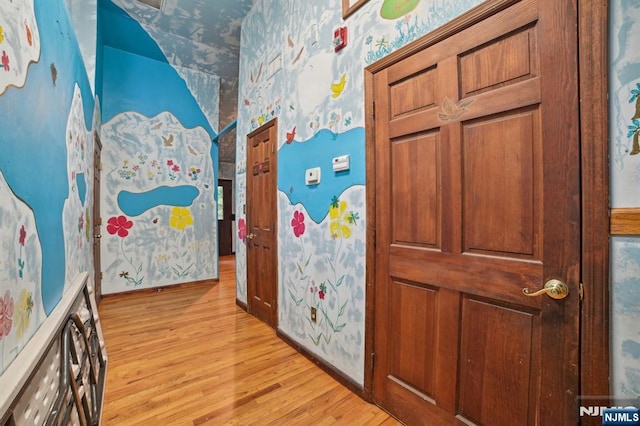 41-21 Dunkerhook Rd, Fair Lawn, NJ 07410 - hallway with wallpapered walls, light wood finished floors, and baseboards