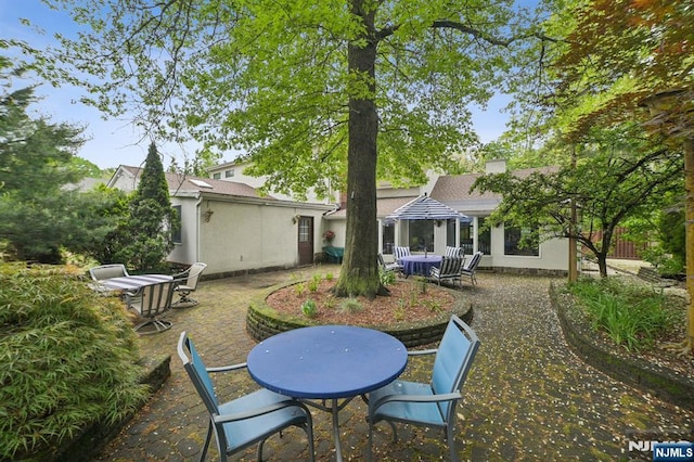 41-21 Dunkerhook Rd, Fair Lawn, NJ 07410 - rear view of property featuring outdoor dining space, a patio, and stucco siding