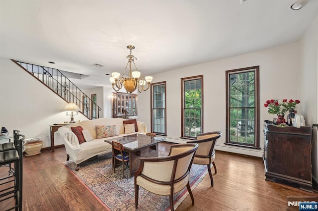 41-21 Dunkerhook Rd, Fair Lawn, NJ 07410 - living room with dark wood finished floors, a chandelier, baseboards, stairs, and baseboard heating
