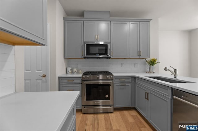 11 Arnold Dr, Wood Ridge, NJ 07075 - kitchen featuring gray cabinets, stainless steel appliances, a sink, light countertops, and decorative backsplash