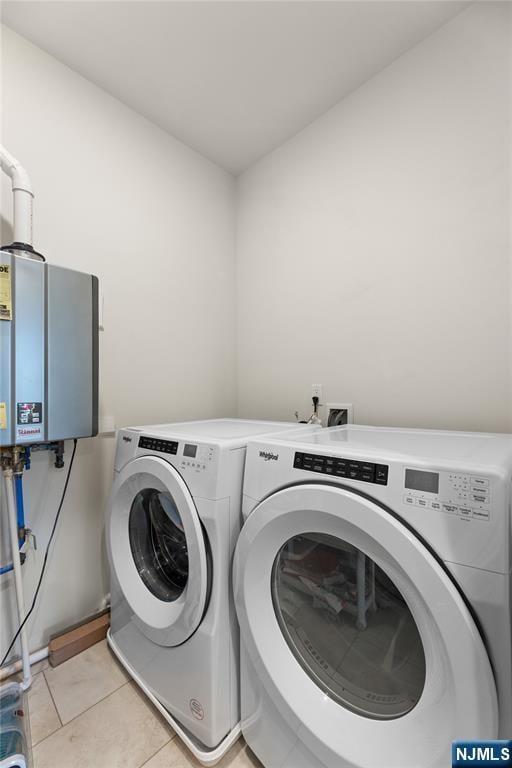 11 Arnold Dr, Wood Ridge, NJ 07075 - clothes washing area with washer and clothes dryer, water heater, and light tile patterned floors
