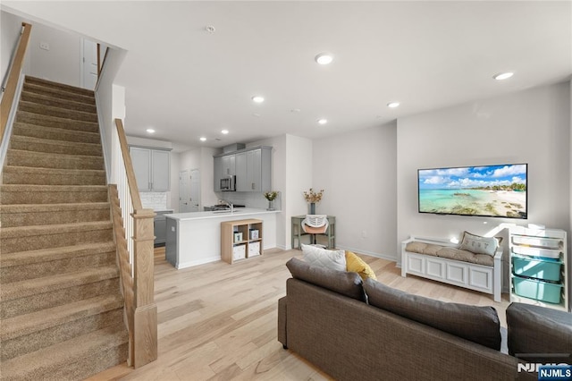 11 Arnold Dr, Wood Ridge, NJ 07075 - living area with light wood finished floors, recessed lighting, stairs, and baseboards