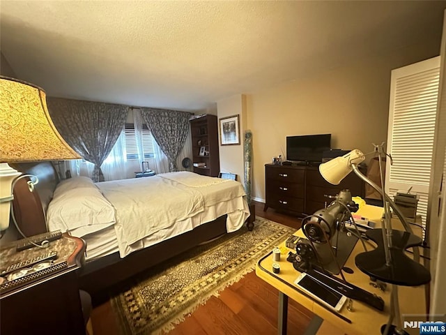 245 Prospect Ave Unit 5B, Hackensack, NJ 07601 - bedroom with wood finished floors and a textured ceiling