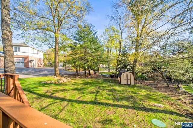 132 Hiawatha Blvd, Oakland, NJ 07436 - view of grassy yard with a storage unit and an outdoor structure