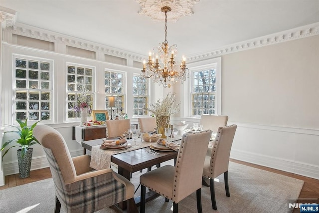 dining room featuring a chandelier and wainscoting