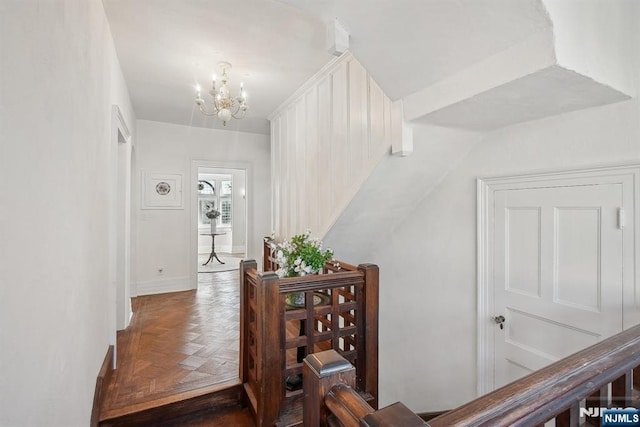 staircase with a chandelier and baseboards