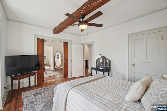 bedroom with wood finished floors, a ceiling fan, and beamed ceiling