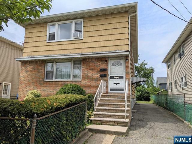 10 Strong St, Wallington, NJ 07057 - view of front of property with entry steps, brick siding, and cooling unit