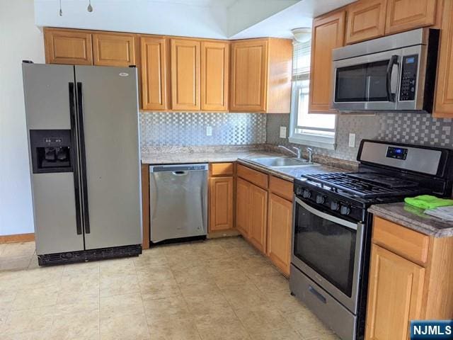 10 Strong St, Wallington, NJ 07057 - kitchen with appliances with stainless steel finishes, a sink, and backsplash