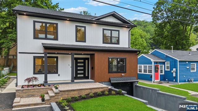view of front of house featuring a shingled roof and a porch