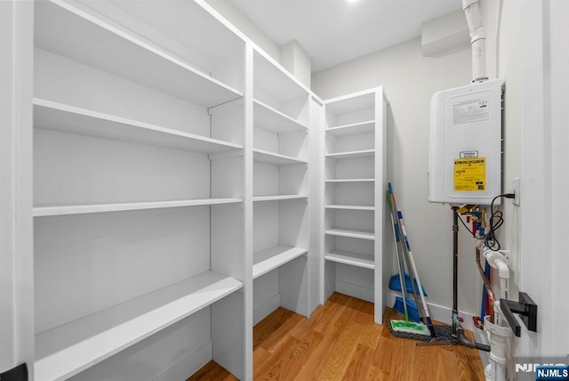 storage area featuring tankless water heater