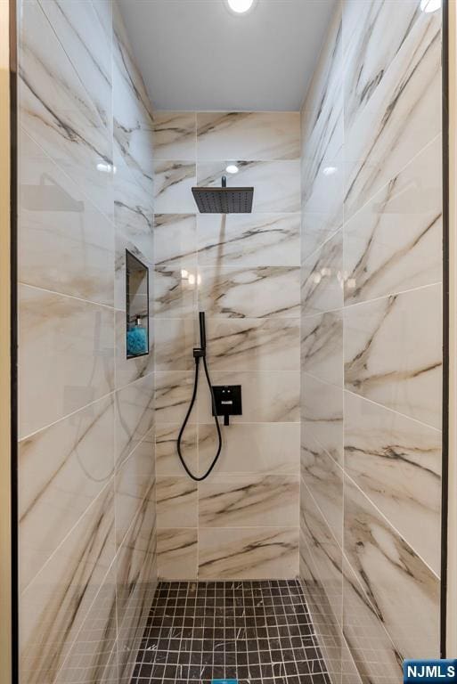 bathroom with a marble finish shower