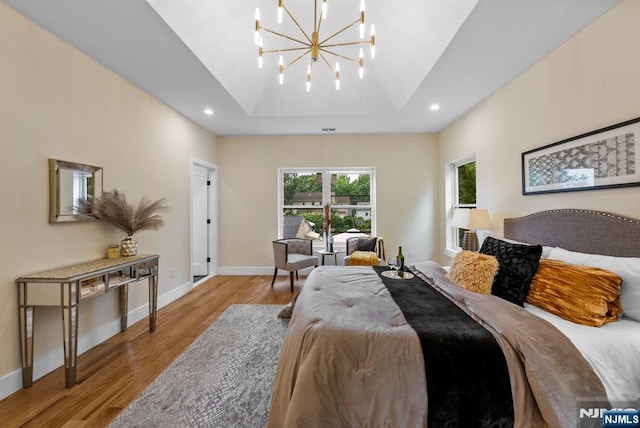 bedroom featuring light wood finished floors, a chandelier, recessed lighting, and baseboards