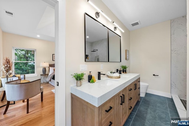 full bathroom with a shower, vanity, toilet, and baseboards