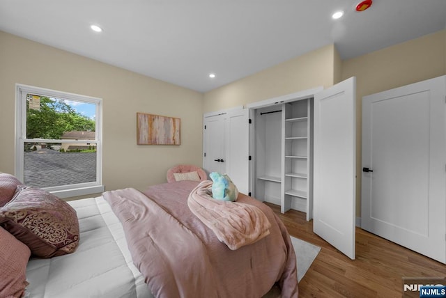 bedroom featuring wood finished floors and recessed lighting