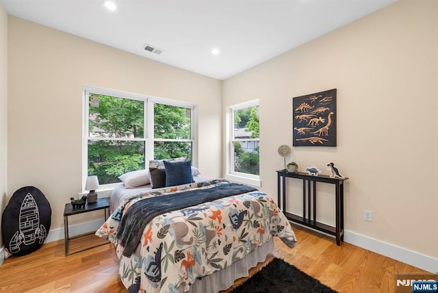 bedroom with light wood finished floors, baseboards, and recessed lighting