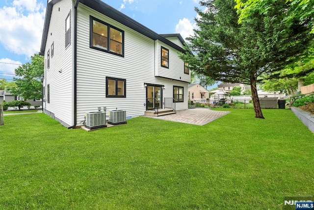 rear view of house featuring central AC unit and a patio area