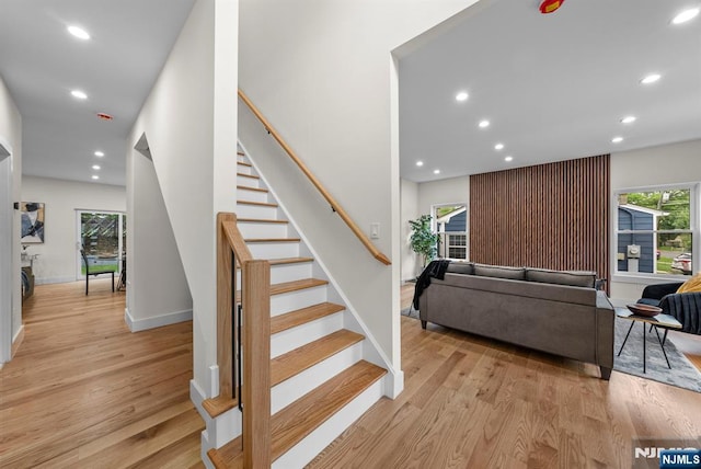 staircase featuring recessed lighting, wood finished floors, and baseboards