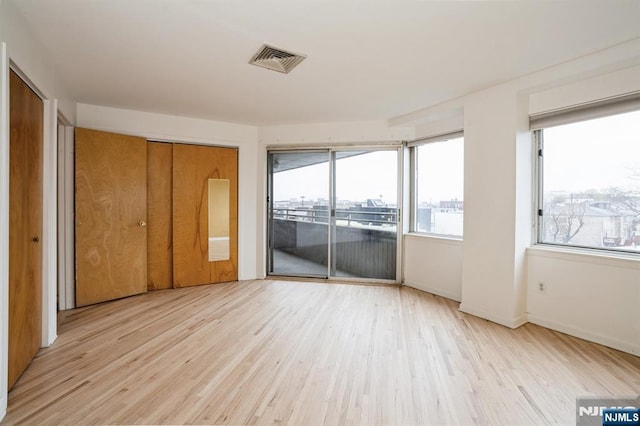 364 Palisade Ave Unit 4C, Cliffside Park, NJ 07010 - unfurnished bedroom featuring access to exterior, wood finished floors, and multiple windows