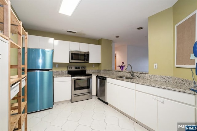 364 Palisade Ave Unit 4C, Cliffside Park, NJ 07010 - kitchen with stainless steel appliances, white cabinetry, light stone countertops, and recessed lighting