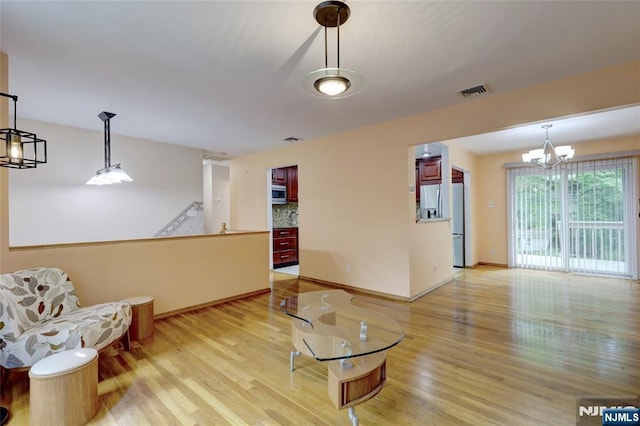 27 Ellen Ln, Wayne, NJ 07470 - living area featuring light wood finished floors, a chandelier, and baseboards