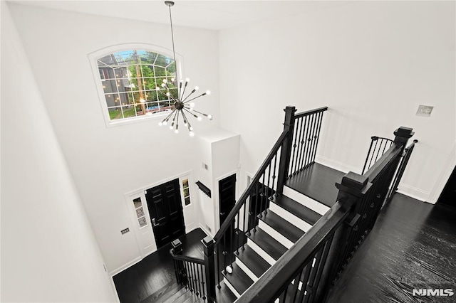 9 Summit Ave, Butler Borough, NJ 07405 - stairway featuring a chandelier, baseboards, and wood finished floors