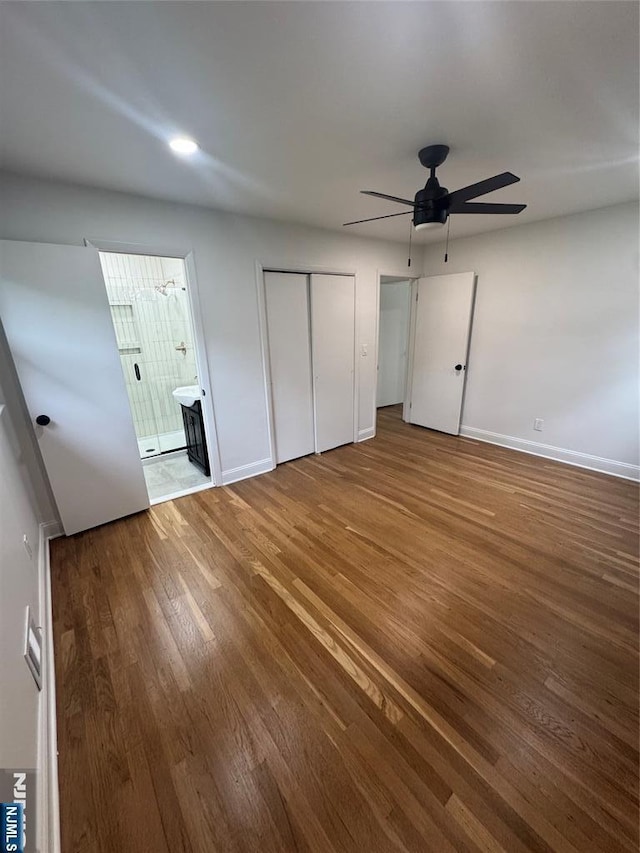 358 Bowden Rd, Cedar Grove, NJ 07009 - unfurnished bedroom with wood finished floors, baseboards, ensuite bath, and a ceiling fan