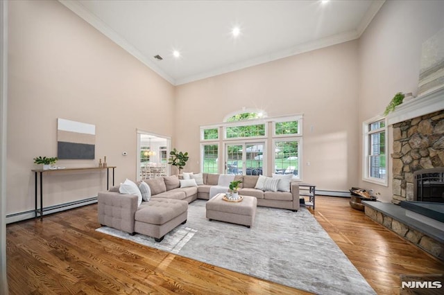 17 Sunset Ln, Upper Saddle River, NJ 07458 - living room with a baseboard heating unit, ornamental molding, a towering ceiling, wood finished floors, and a fireplace